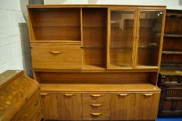 A laminate teak effect wall unit, dimensions approx. W192 D54 H184cm