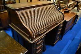 A late 19th or early 20th Century oak roll top desk having S tambour top, width approx. 127cm