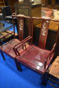 A pair of Oriental hardwood carver chairs having mother of pearl inlay decoration