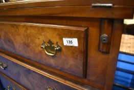 A reproduction Regency bureau chest of four drawers, having fold over top and pull out supports,