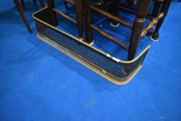 A pierced brass fire fender