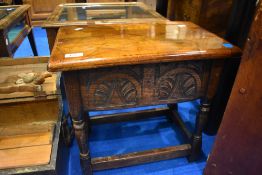 A traditional oak storage table of small proportions