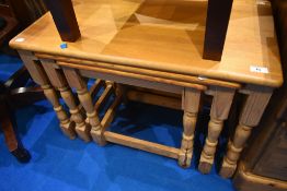 A natural pine nest of three tables, largest table being approx 73 x 41cm