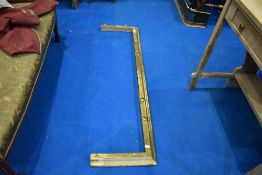 A traditional brass fire fender