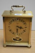 A brass 'Timemaster' mantel clock in German case.