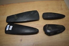 A group of four Oceanic axe heads and cooking implements, of Papua New Guinea origin, the largest