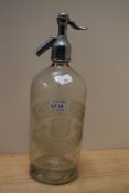 A vintage soda syphon bottle for 'Specially prepared table waters in porcelain lined syphons'.