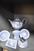 An assorted collection of Wedgwood blue jasperware, to include a teapot, table lighter, and flared