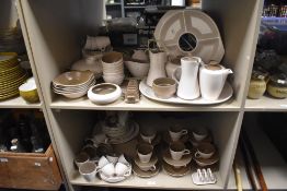 A large collection of Poole Pottery in fawn and coffee colour way, including toast rack, cups and