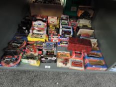 A shelf of modern die-casts including ERTL Farm Implements, Lledo Land Speed Legends, Action