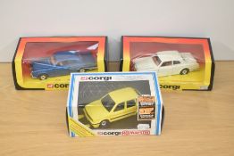 Three Corgi die-casts, 279 Rolls Royce Corniche x2 in white and blue, 1009 MG Maestro in yellow, all