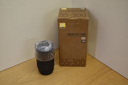 A Nikon Nikkor AF-S DX Nikkor 55-300mm 1:4,5-5,6G ED VR lens for digital camera in original box