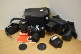 A Zenit EM Olympic camera with a Helios -44 lens, and a Hanimex Automatic 1:2,8 135mm lens