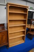 A modern golden oak effect bookcase, approx dimensions W100 H200 D31cm