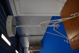 A vintage metal torchere or plant stand