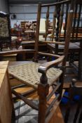 A 19th Century rocking chair having triple spindle back and strung seat