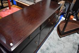 A Stag sideboard, width approx. 141cm sold with matching bedside chest