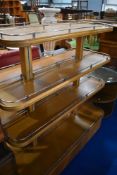An Art Deco golden oak display stand having adjustable sprung shelves with chrome galleried