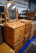 A modern pine tall bedroom chest, two bedside cabinets and dressing table mirror
