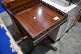 A nice quality reproduction galleried pedestal table having carved column, triple splay legs and