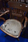 A vintage stained frame swivel office chair