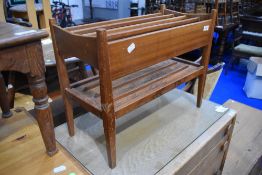 A vintage teak paper rack