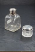 A George III silver topped glass dressing table jar, of moulded circular form with remains of