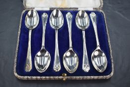 Golfing interest*A cased set of six George V silver coffee spoons, the trefoil surmounts with
