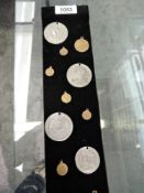 A collection of Coronation Medallions, Queen Victoria, Edward VII & George V all on display sash