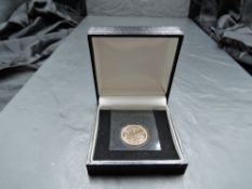A Royal Mint United Kingdom 2000 Queen Elizabeth II Gold Proof Sovereign, in plastic wallet and