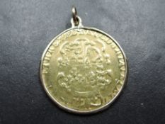 A 1782 George III Gold Guinea, shield back, in loose fitting yellow metal mount, possible 9ct but
