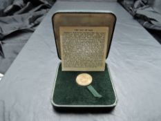 A 1965 Elizabeth II Isle of Man Gold Sovereign, in original folding case with card page