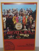 A Beatles framed Sgt Pepper poster - frame has a crack 62 x 92 cm - poster is in excellent