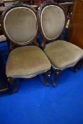 A pair of French style oak salon chairs having dralon upholstery