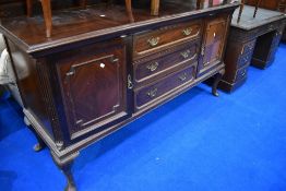 A late 19th or early 20th Century mahogany sideboard having three central drawers, flanked by