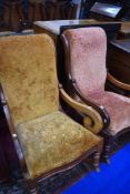 A pair of Victorian mahogany rocking chairs having scroll frames
