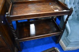 An early 20th Century oak tea trolley having barley twist frame