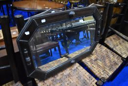 An early 20th Century Jacobean style oak canted wall mirror, approx 83 x 53cm