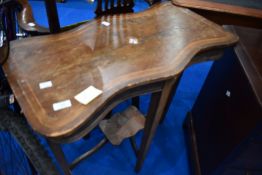 An Edwardian shaped occasional table having mahogany shaped top with inlay including mother of pearl