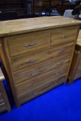 A modern golden oak bedroom chest of two over four drawers, approx. W99 D44 H108cm
