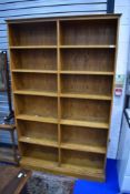 A modern oak laminate library bookshelf, having fixed shelves, dimensions approx. W123 D28 H203cm