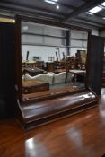 A late 19th or early 20th Century wall or dressing table mirror with bow front trinket section to