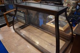 An Edwardian mahogany display cabinet top of shaped form with brass inlay and open base, with lift