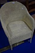 A vintage Lloyd Loom tub chair, in cream
