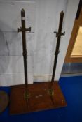 An ecclesiastical style pine shelf having brass supports