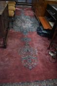 A traitional room sized carpet square, having some slits cut out to ends, approx. 495 x 372cm