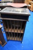 A vintage mahogany 'pigeon hole' style letter or LP rack and a small oak display cabinet