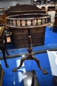 A Reprodux tripod table having galleried top and ball and claw feet