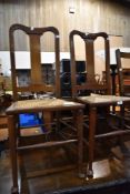 A pair of stained frame bedroom chairs having bergere cane seats
