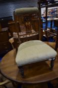 A Victorian mahogany nursing chair having shield back and later dralon upholstery